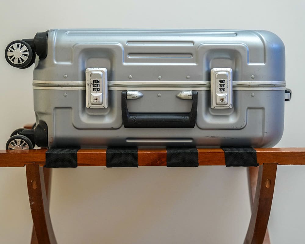 When travelling, keep luggage off hotel beds and inspect seams for signs of bed bugs.